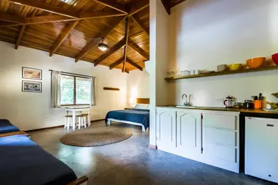 a kitchen and living room with a couch and a table at The Sunset Shack in Nosara