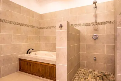 a bathroom with a tub and a shower at Villa Cielo in Jacó