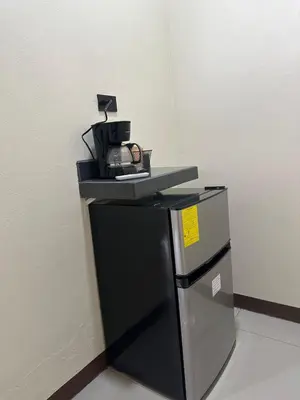 a black refrigerator with a shelf on top of it at Cabinas Las Veraneras - Dota in Santa María
