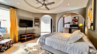 a bedroom with a bed and a ceiling fan at Ruta Verde BB in Tambor