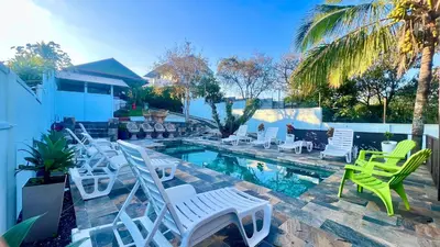 a group of chairs sitting around a swimming pool at Ruta Verde BB in Tambor