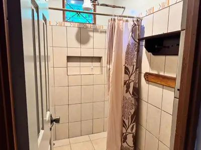 a bathroom with a shower with a shower curtain at Casa Mia playa Tambor in Tambor