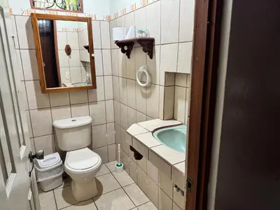 a bathroom with a toilet and a sink and a tub at Casa Mia playa Tambor in Tambor