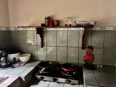 a kitchen with two pots and pans on a stove at Casa Mia playa Tambor in Tambor