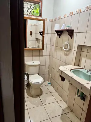 a bathroom with a toilet and a sink and a mirror at Casa Mia playa Tambor in Tambor