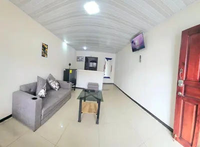 a living room with a couch and a table at Apartaestudio Cabo Verde in San José
