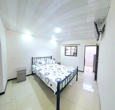 a bedroom with a bed in a white room at Apartaestudio Cabo Verde in San José