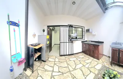 a kitchen with a refrigerator and a table in a room at Apartaestudio Cabo Verde in San José