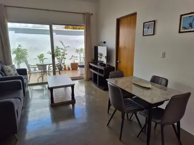 a living room with a table and a couch at CasaMar 2BD & 2BA in Jacó