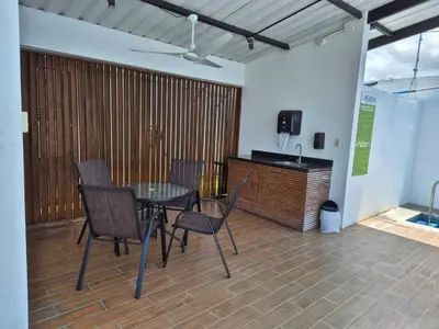 a patio with a table and chairs and a television at CasaMar 2BD & 2BA in Jacó