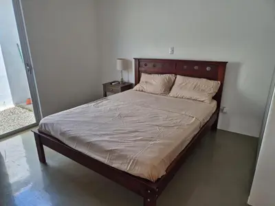 a bed with a wooden headboard in a bedroom at CasaMar 2BD & 2BA in Jacó