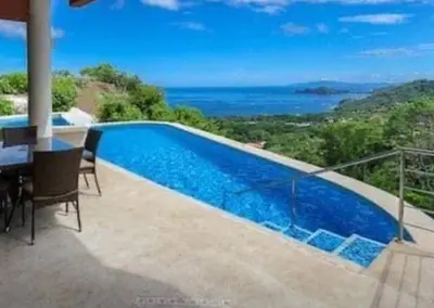 a swimming pool on a balcony with a view of the ocean at Hermosa Heights Villa 58 in Playa Hermosa