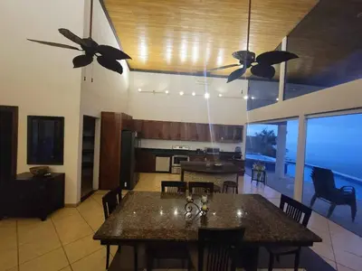 a kitchen with two ceiling fans and a dining room at Hermosa Heights Villa 58 in Playa Hermosa