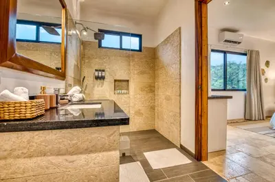 a bathroom with a sink and a shower at Blue Jungle Lodge in Arenal