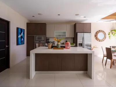 a kitchen with a island in the middle of a room at Casa White#2 Beautiful modern beach house in Sámara