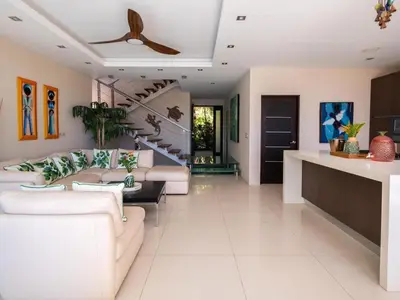 a living room with white furniture and a staircase at Casa White#2 Beautiful modern beach house in Sámara
