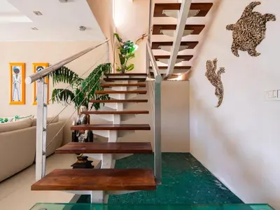 a staircase in a house with a green floor at Casa White Duplex Beautiful beach houses in Sámara
