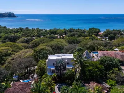 an aerial view of a house with the ocean in the background at Casa White Duplex Beautiful beach houses in Sámara