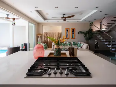 a kitchen with a stove top on a counter at Casa White Duplex Beautiful beach houses in Sámara