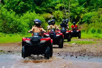 a group of people riding on atvs through a river at Monaco Condominiums, Jacó, Costa Rica - Luxury 3 Bedrooms in Jacó