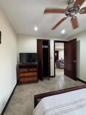 a bedroom with a bed and a flat screen tv at Monaco Condominiums, Jacó, Costa Rica - Luxury 3 Bedrooms in Jacó