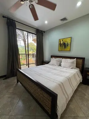 a bedroom with a large bed with a ceiling fan at Monaco Condominiums, Jacó, Costa Rica - Luxury 3 Bedrooms in Jacó
