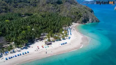 an aerial view of a beach with umbrellas and the ocean at Monaco Condominiums, Jacó, Costa Rica - Luxury 3 Bedrooms in Jacó