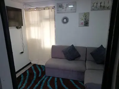 a living room with a couch and a window at Casa Amiga in San José