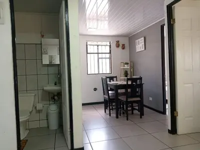 a kitchen and dining room with a table and chairs at Casa Amiga in San José