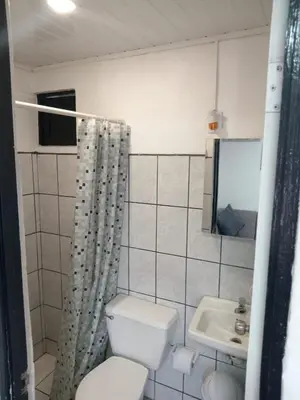 a bathroom with a toilet and a sink at Casa Amiga in San José