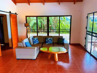a living room with a couch and a coffee table at Casa Nekori Wonderful Mountain view 15 minutes from Samara in Nicoya