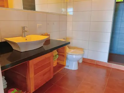 a bathroom with a sink and a toilet at Casa Nekori Wonderful Mountain view 15 minutes from Samara in Nicoya
