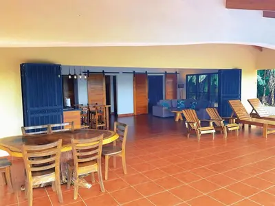 a dining room with a wooden table and chairs at Casa Nekori Wonderful Mountain view 15 minutes from Samara in Nicoya