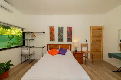 a bedroom with a white bed and a window at Modern studio near Santa Teresa beach in Boca de Ario