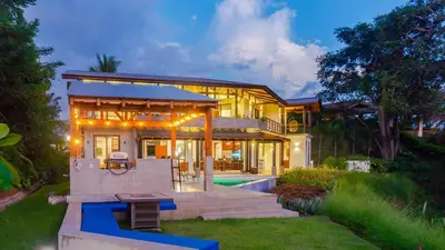 a large house with a patio and a pool at Villa Hermanos Luxury Home with Ocean View in Sámara