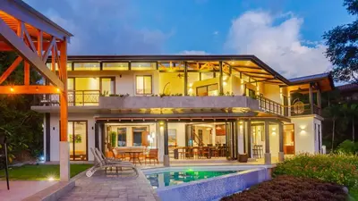 a large house with a pool in front of it at Villa Hermanos Luxury Home with Ocean View in Sámara
