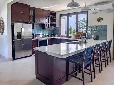 a kitchen with a large island with a counter top at Villa Hermanos Luxury Home with Ocean View in Sámara