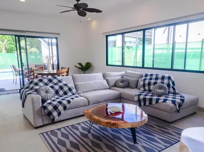a living room with a couch and a table at Casa Jurassic Amazing villa 10 min walk to the beach in Sámara
