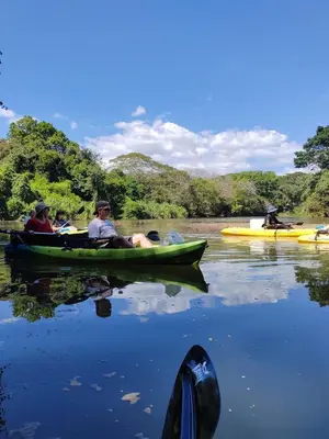 a group of people in a canoe on a river at Casa Jurassic Amazing villa 10 min walk to the beach in Sámara