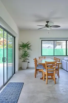 a dining room with a table and chairs at Casa Cretaceous Modern villa 10 min walk to the beach in Sámara