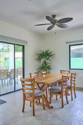 a dining room with a wooden table and chairs at Casa Cretaceous Modern villa 10 min walk to the beach in Sámara