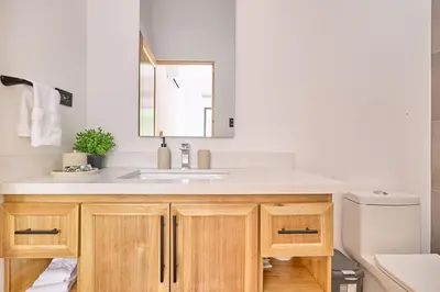 a bathroom with a sink and a mirror at Casa Cretaceous Modern villa 10 min walk to the beach in Sámara