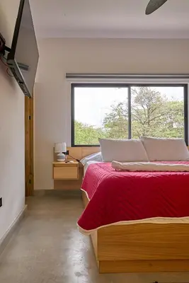 a bedroom with a bed and a large window at Casa Cretaceous Modern villa 10 min walk to the beach in Sámara