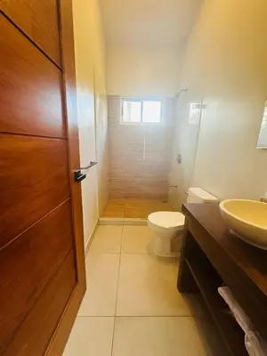 a bathroom with a toilet and a sink at Casa Hilltop Peaceful house 15 minutes from Samara in Sámara