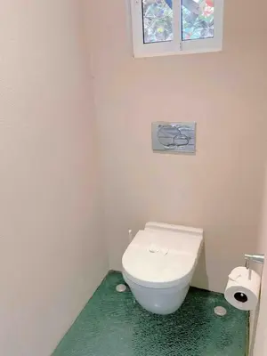 a bathroom with a white toilet and a window at Casa Blanca #1 Beautiful modern beach house in Sámara