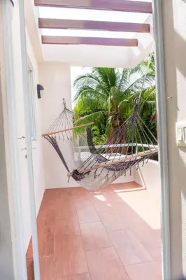 a hammock in the hallway of a house at Casa Blanca #1 Beautiful modern beach house in Sámara