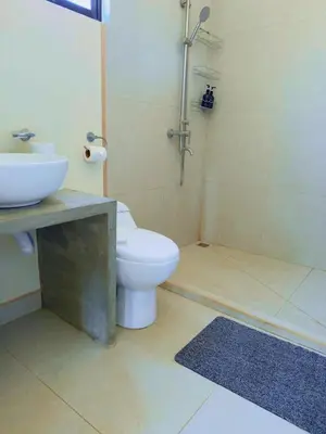 a bathroom with a toilet and a sink and a shower at Casa Flores Ocean view 10 min to Carrillo in Sámara