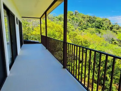 a balcony with a view of the mountains at Casa Flores Ocean view 10 min to Carrillo in Sámara