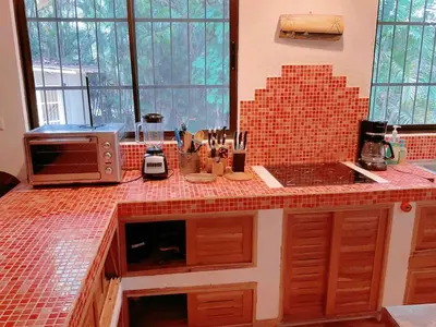 a kitchen with a counter top with a microwave at Casa Francesca Beautiful house with a large garden in Sámara