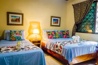 a bedroom with two beds with stuffed animals on them at Aloha Surf Nosara - Casa 'Ohana in Nosara
